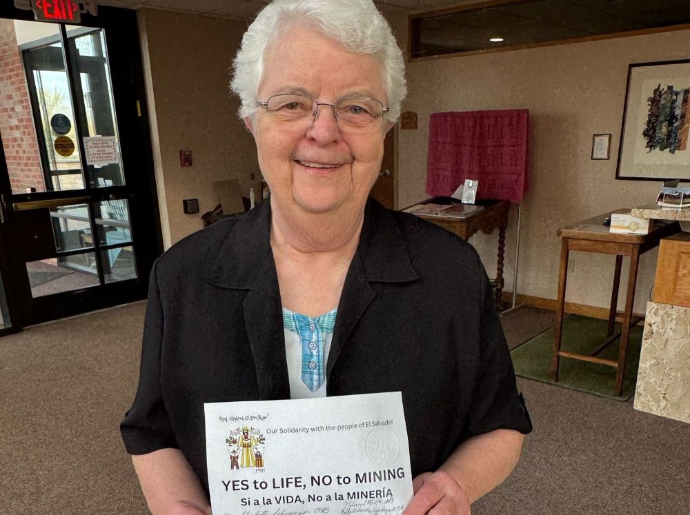Benedictine Sr. Mary Elizabeth Schweiger holds a petition against mining in El Salvador