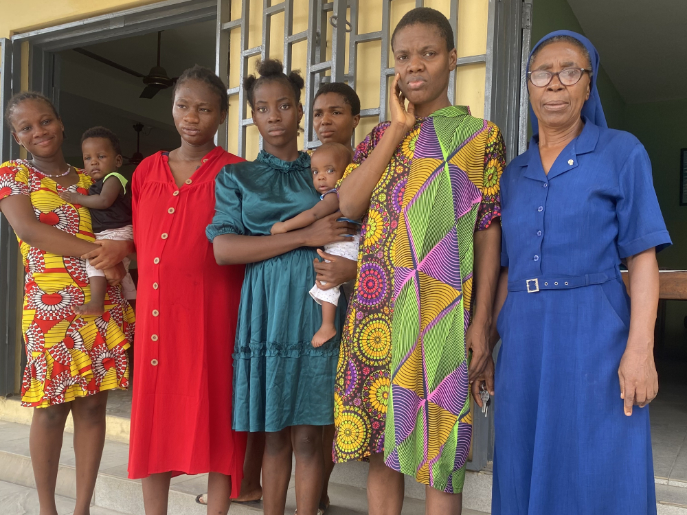 Young women and girls at the Ozanam House pose for a photo with Sr. Mary Okeke, program coordinator at the Ozanam House. (Valentine Benjamin)