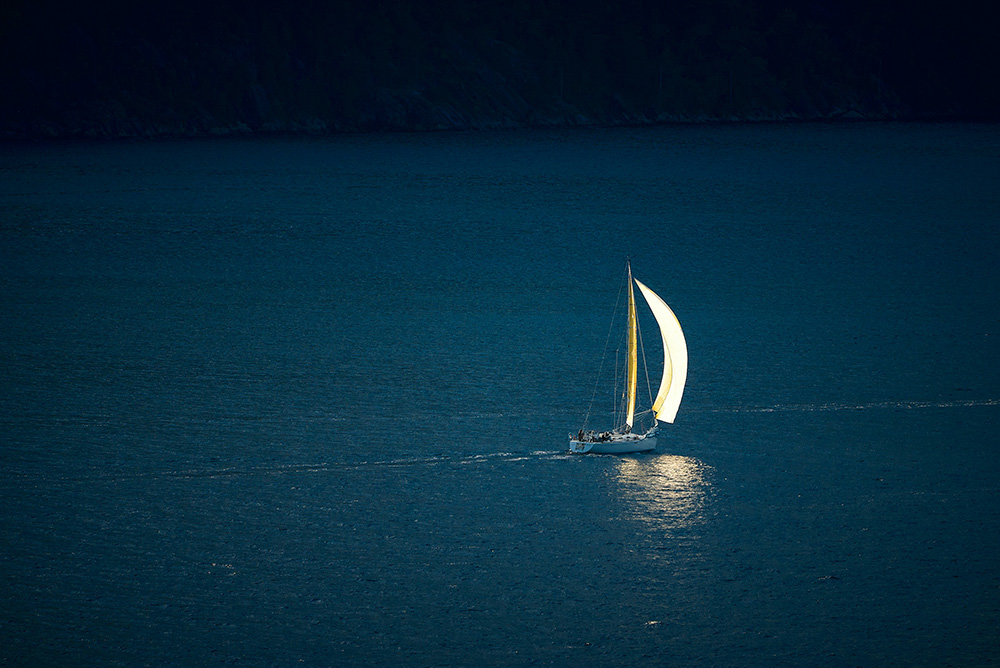 Sailboat on dark blue waters (Unsplash/Vidar Nordli Mathisen)