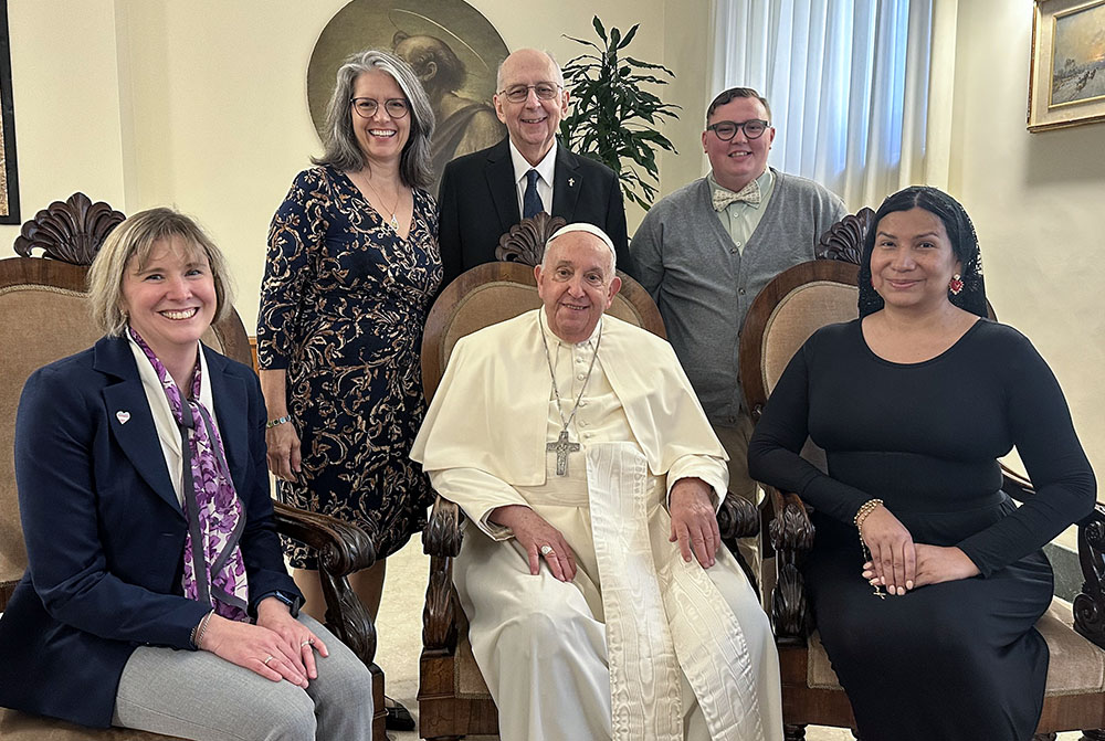 Pope Francis poses for a photo with a delegation from New Ways Ministry during a meeting at his residence at the Vatican Oct. 12, 2024. Pictured from left are Cynthia Herrick, Laurie Dever, Deacon Ray Dever, Michael Sennett and Nicole Santamaria. (CNS/Courtesy of New Ways Ministry)