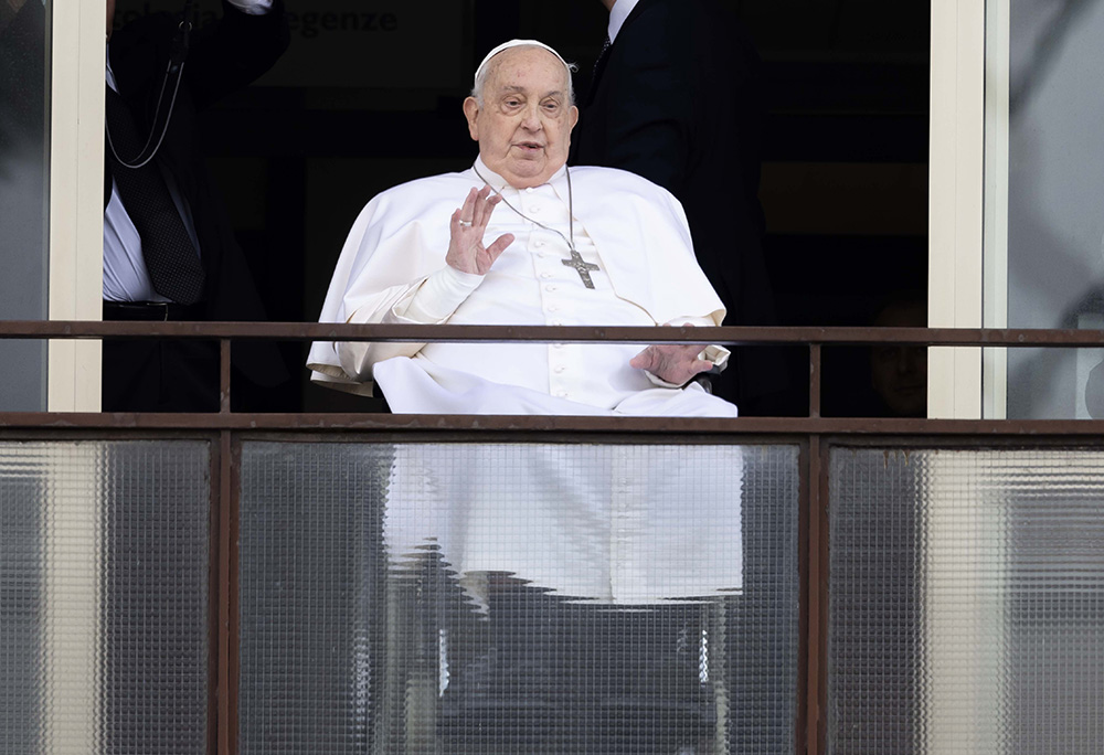 Pope Francis waves to a crowd of well-wishers at Rome's Gemelli hospital before returning to the Vatican March 23, 2025, after 38 days of treatment at the hospital. (CNS/Pablo Esparza)