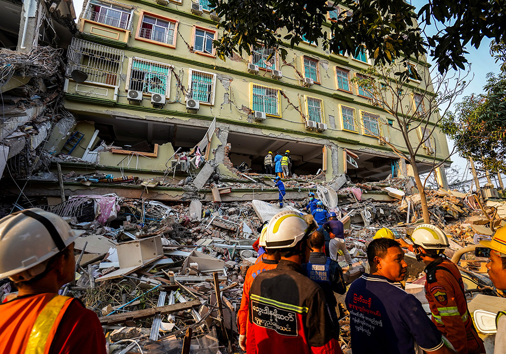 Rescuers work at the site of a damaged building in Mandalay, Myanmar, March 30, in the aftermath of a strong earthquake that struck two days earlier. People in Myanmar are in desperate need of humanitarian supplies and medical support as the death toll from the devastating earthquake that rocked central Myanmar continues to rise. (OSV News/Reuters)