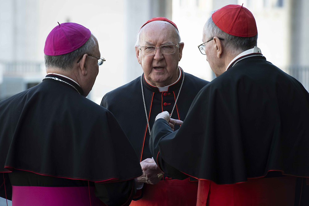 U.S. Cardinal Kevin Farrell, chamberlain of the Holy Roman Church, speaks with Archbishop Ilson Montanari, secretary of the College of Cardinals, right, and Cardinal Pietro Parolin, Vatican secretary of state under Pope Francis, after the first general congregation of the College of Cardinals in the Vatican Synod Hall April 22, 2025. (CNS/Vatican Media)
