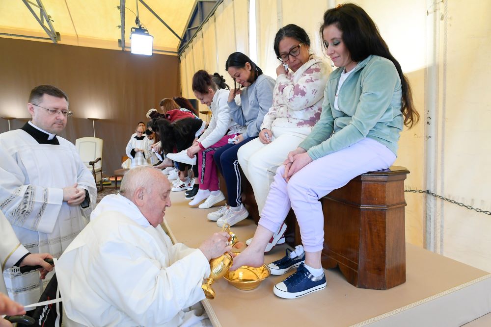 Pope Francis washes the feet of an inmate at the Rebibbia women's prison.