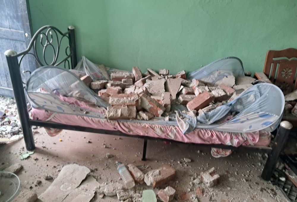 bed covered with chunks of building debris