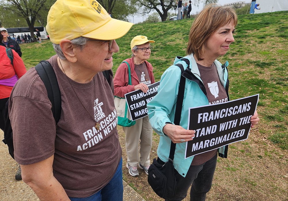 Sr. Maria Orlandini, left, Sr. Marie Lucey, center, and Michele Dunne, executive director of the Franciscan Action Network, right, all represented the network during the April 5 "Hands Off!" demonstration in Washington, D.C. (GSR photo/Chris Herlinger)