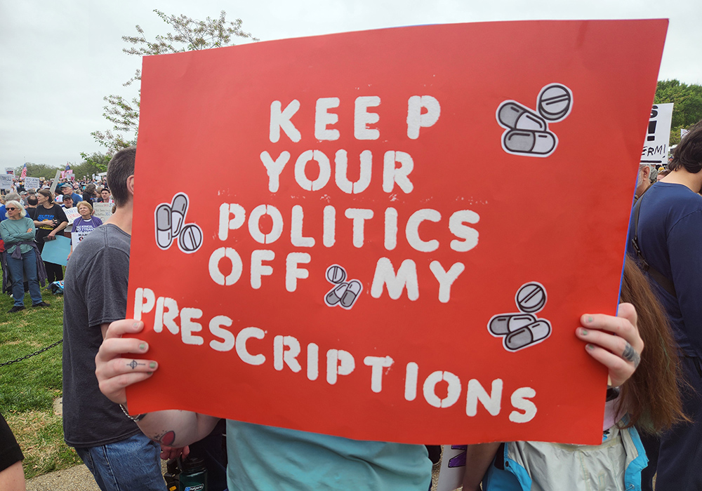 A sign critical of President Donald Trump's policies during the April 5 "Hands Off!"  demonstration in Washington, D.C. (GSR photo/Chris Herlinger)