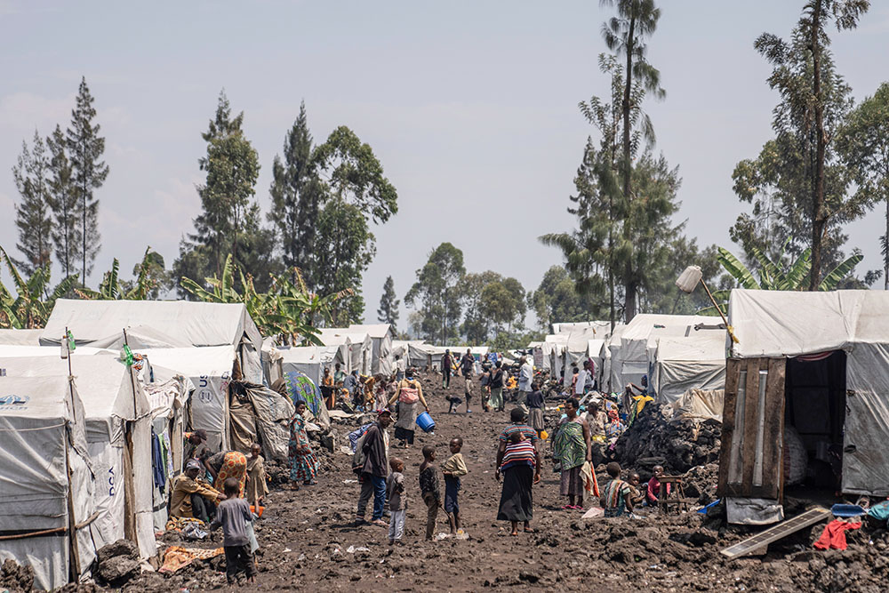Internally displaced people fleeing the ongoing conflict with M-23 rebels gather in the Blushagala camp outside Goma, Democratic Republic of the Congo, on Aug. 29, 2024. (AP/Moses Sawasawa)