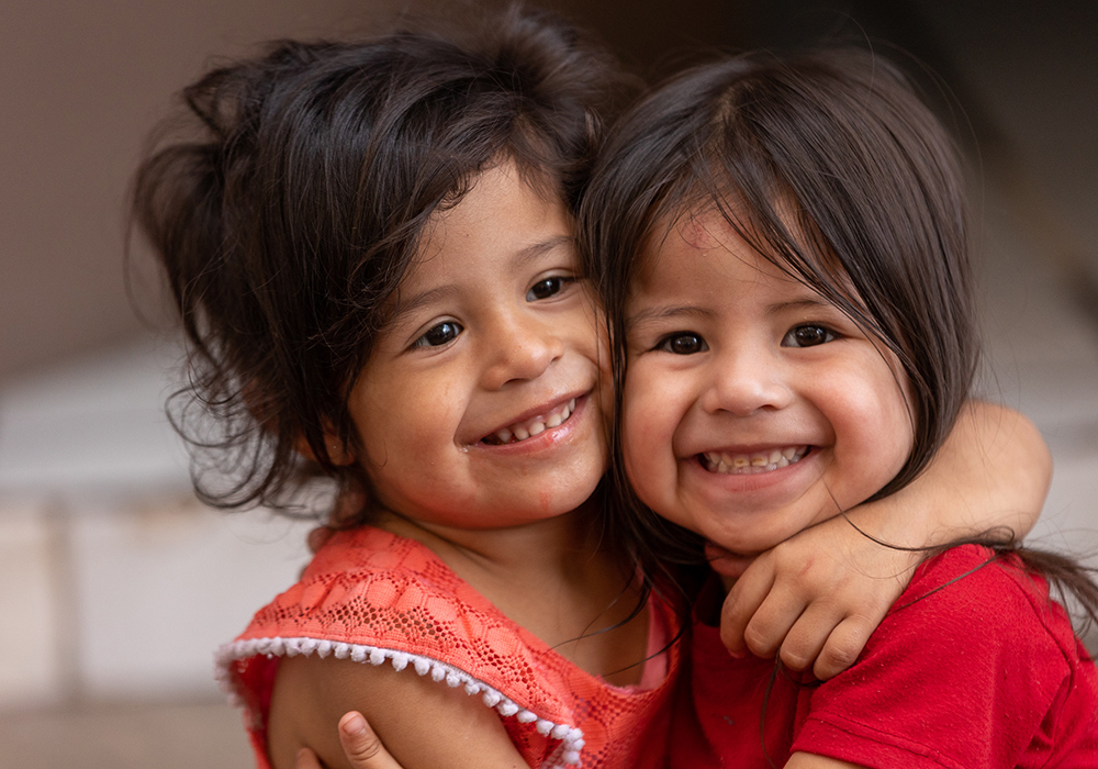 Children staying at the Cobina Posada del Migrante Shelter embrace. Border Compassion often provides toys and art projects for children at the shelter. (Courtesy of Border Compassion)