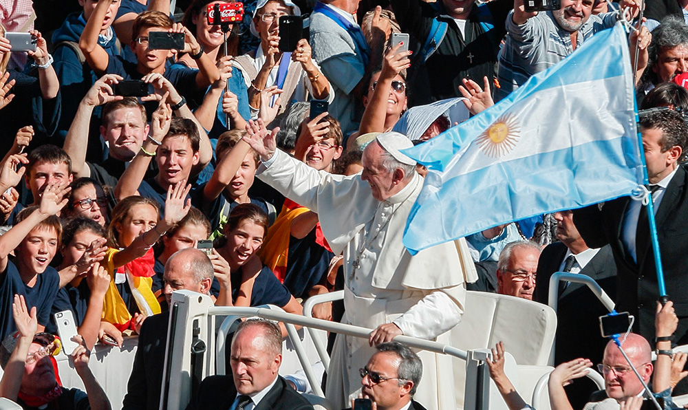 Argentina's flag is seen as Pope Francis greets the crowd after celebrating a canonization Mass for seven new saints in St. Peter's Square at the Vatican Oct. 16, 2016. Among those canonized was Argentine St. José Gabriel del Rosario Brochero, known as the "gaucho priest." (CNS/Paul Haring)