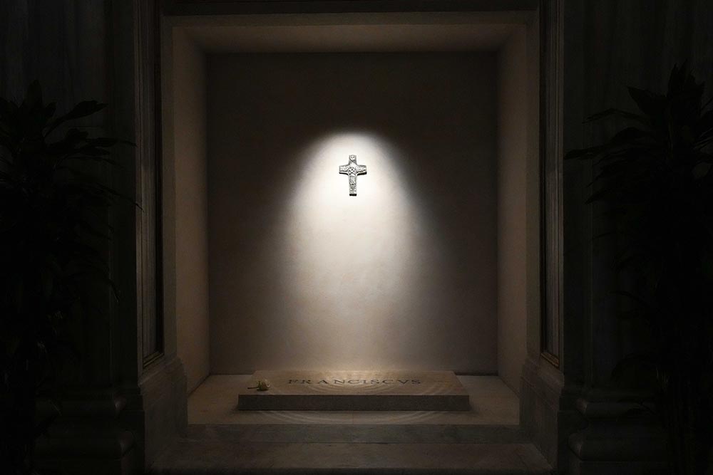 A light shines on a replica of Pope Francis' pectoral cross above his tomb in the side aisle of Rome's Basilica of St. Mary Major early April 27, 2025. (CNS/Lola Gomez)
