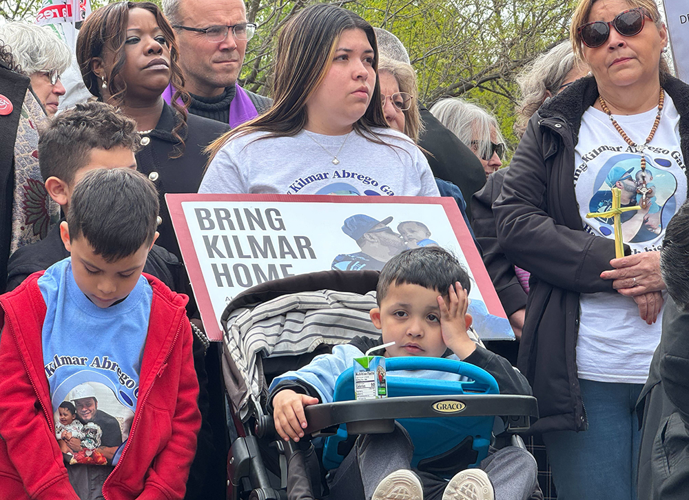 Jennifer Vasquez Sura, middle, holds a sign calling for the liberation of her husband Kilmar Abrego Garcia, during a Holy Week vigil near the White House on April 14 in Washington. Catholics joined the interfaith gathering to pray for the liberation of Abrego and other immigrants sent to a prison in El Salvador. (GSR photo/Rhina Guidos)