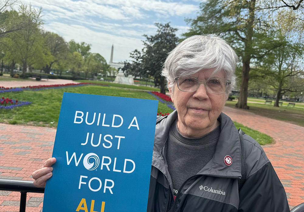 Dominican Sr. Carol Gilbert holds a sign after a Holy Week vigil in front of a park near the White House where people of various faiths prayed April 14 for immigrants who were imprisoned after being deported to El Salvador. The event took place as the U.S. and Salvadoran president met nearby. Gilbert said before the vigil began, authorities had closed the part of the park closest to the White House, perhaps so that those inside wouldn't hear the prayers of those gathered. (GSR photo/Rhina Guidos)