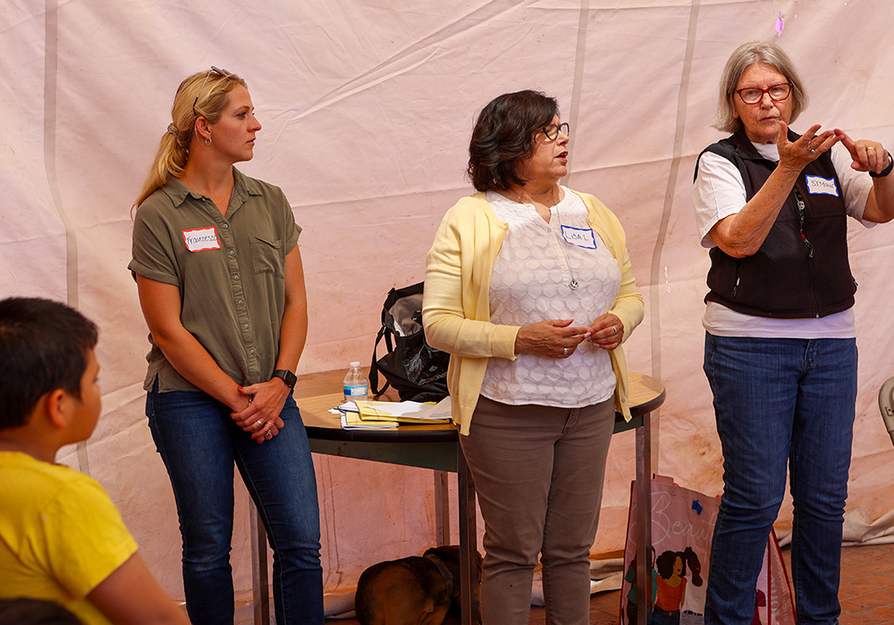 Sr. Simone Campbell (right) and Sr. Lisa Lopez (middle), both members of the Sisters of Social Service, give a presentation about immigration law with another volunteer to residents at the Cobina Posada del Migrante Shelter, one of many regular legal presentations arranged through Border Compassion. (Courtesy of Border Compassion)