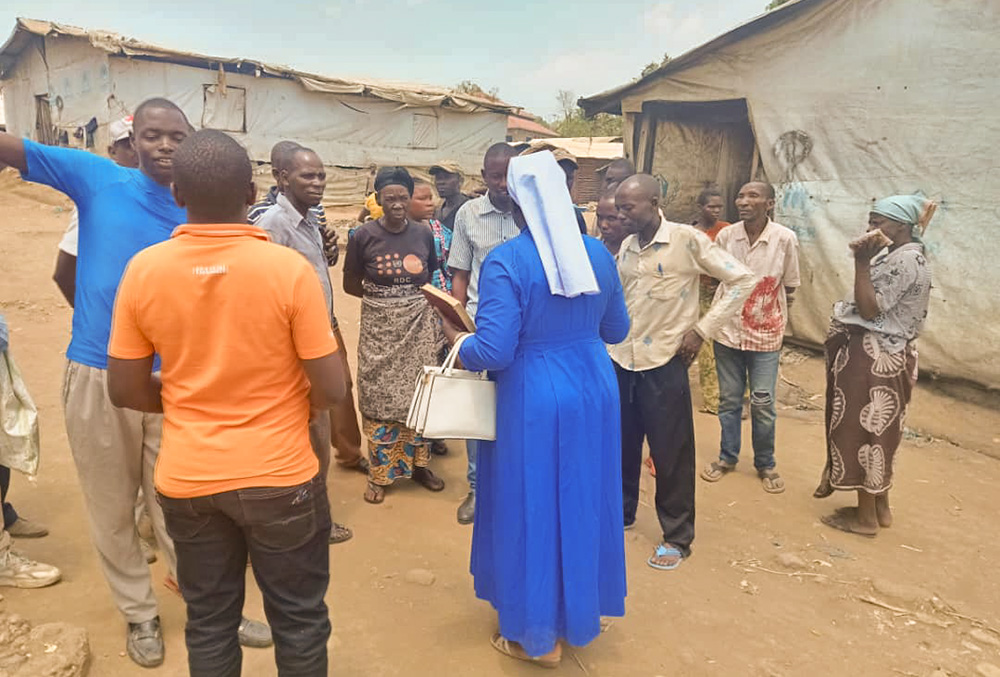 A sister visits displaced individuals, including women and girls, in a camp in the eastern town of Goma, Democratic Republic of Congo. (Courtesy of Caritas)