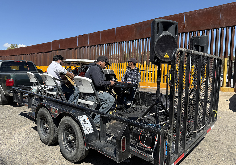 A Via Crucis procession passing by the border wall in Nogales, Mexico, on April 5 included a platform trailer carrying musicians who provided both sacred and popular music acknowledging the sufferings of migrants attempting to get to the U.S. (Anita Snow)