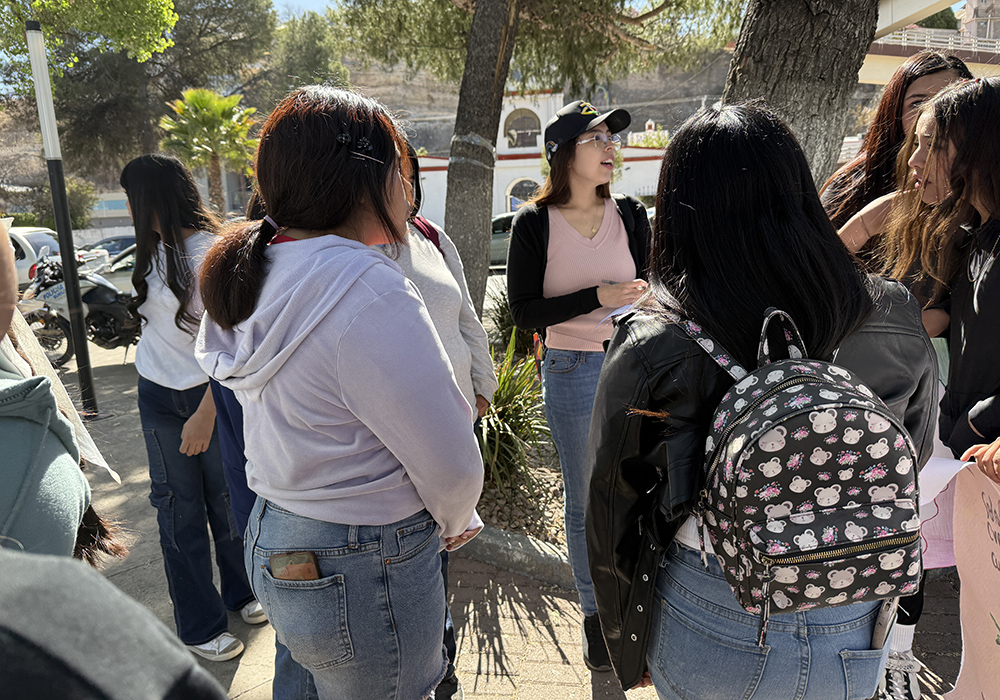 Catechist Gaby Romero, in baseball cap, takes roll call of young people preparing for their first Communion and confirmation with Holy Family Church in Nogales, Mexico, before a symbolic Via Crucis. (Anita Snow)