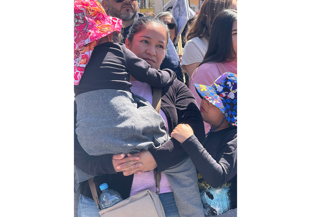 A woman and her two young children take part in a symbolic Via Crucis organized by the Kino Border Initiative, April 5 in Nogales, Mexico, in honor of migrants. (Anita Snow)