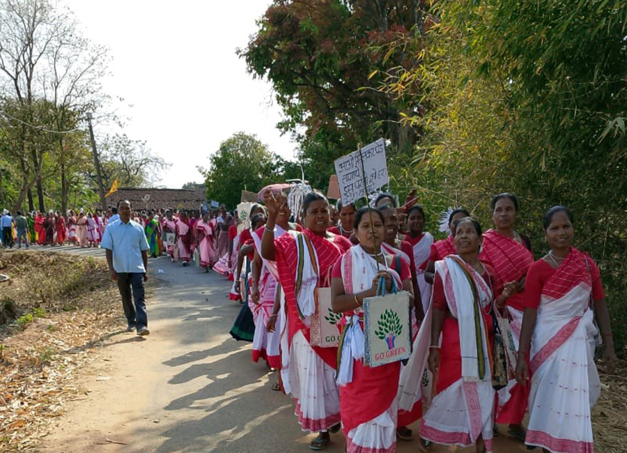 Women from a self-help group in Tirra, Jharkhand, India, display "Go Green" placards, demonstrating their dedication to environmental awareness. (Courtesy of Deepa Moonjely)