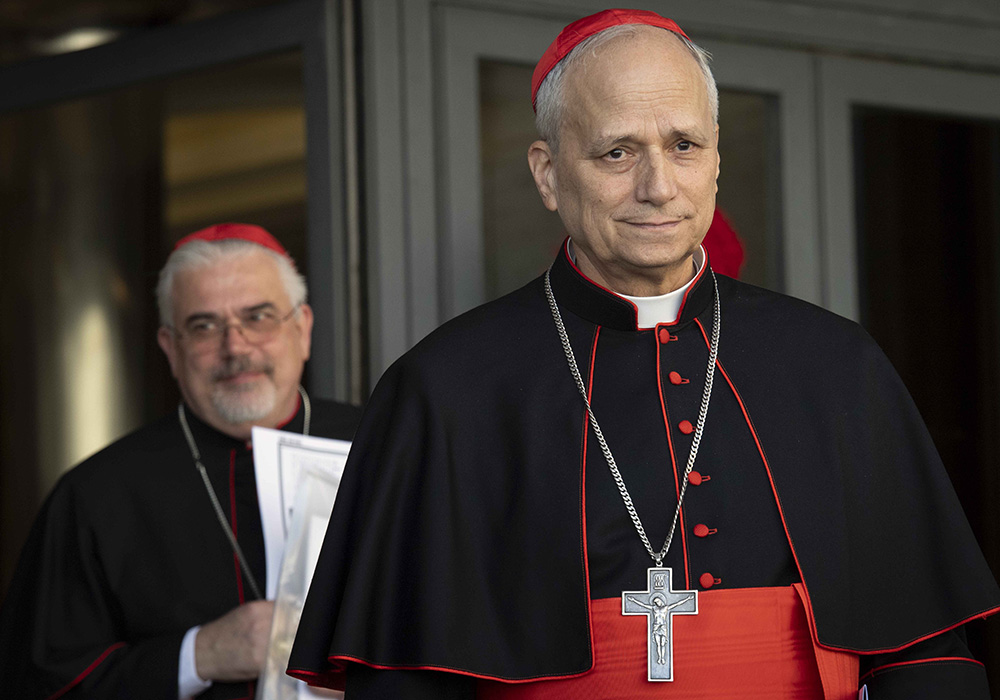 U.S.-born Cardinal Robert Prevost, prefect of the Dicastery for Bishops under Pope Francis, leaves the Vatican Synod Hall April 22, 2025, after the first general congregation of the College of Cardinals. Cardinal Fabio Baggio, undersecretary of the Dicastery for Promoting Integral Human Development, walks out behind him. (CNS/Vatican Media)