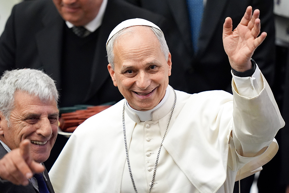 Pope Leo XIV greets photographers as he welcomes members of the media who covered his election, during a meeting in the Paul VI Audience Hall at the Vatican May 12, 2025. (CNS/Lola Gomez)