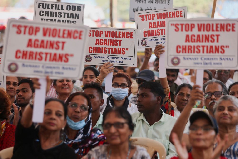 People hold placards during a protest in Mumbai, India.