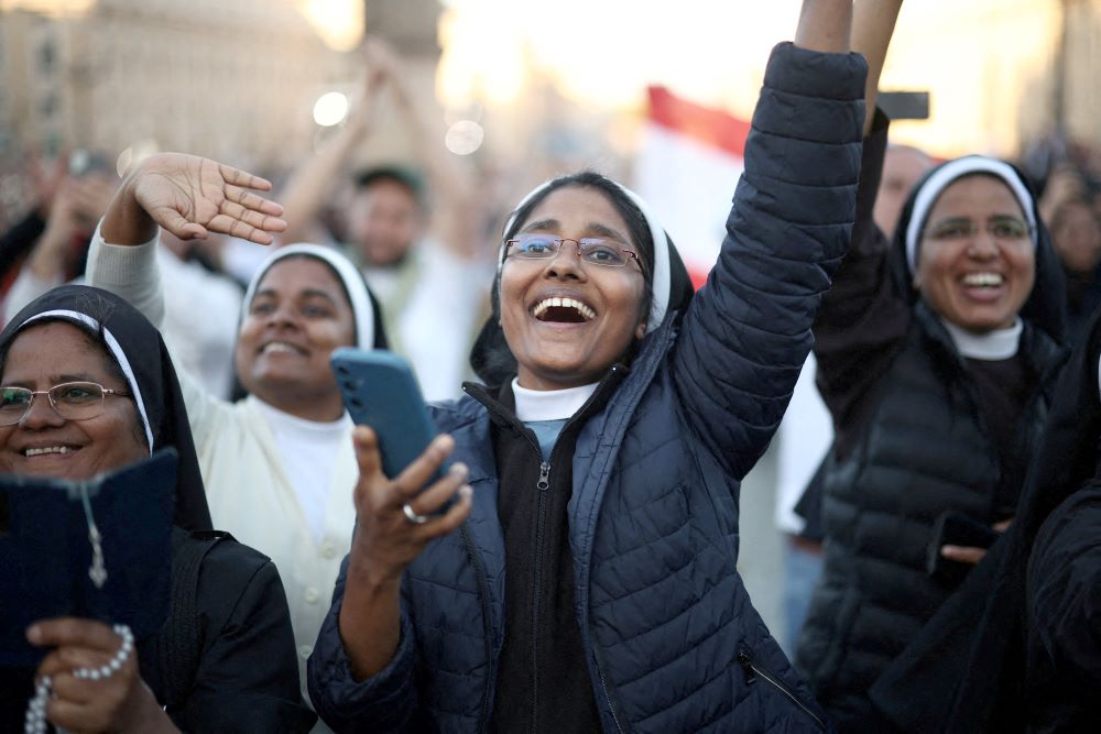 Sisters cheer as Pope Leo XIV appears.
