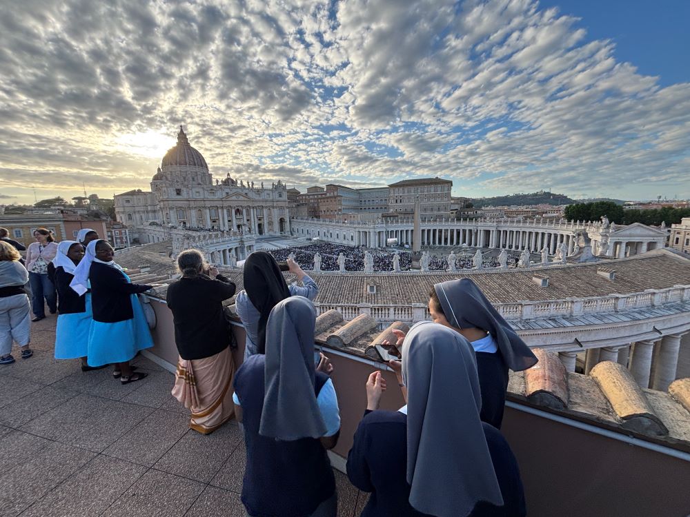 Nuns watch St. Peter's Square from nearby roof. Nuns watch St. Peter's Square from nearby roof.