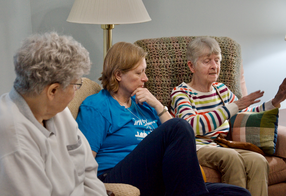 From left, Srs. Emily Meehan and Kristi DeNeve listen to Sr. Pat Quinn talk about sisters from different congregations living together at the motherhouse of the Sisters of St. Joseph of Carondelet in St. Louis. DeNeve and Quinn are St. Joseph sisters; Meehan is from the Congregation of Divine Providence. (GSR photo/Dan Stockman)