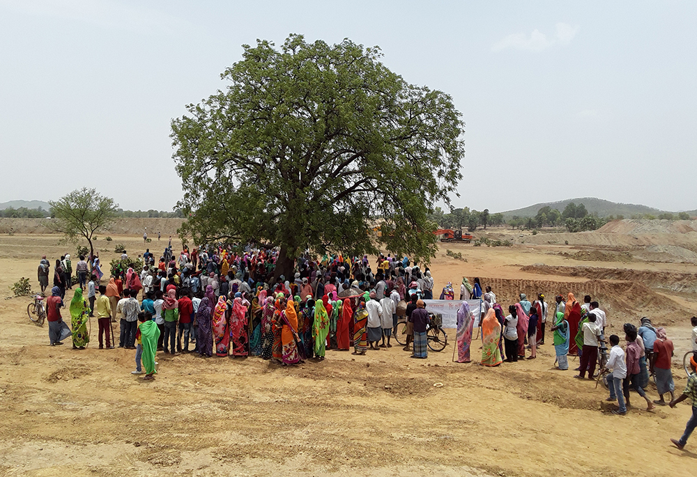 Villagers from six communities gather under a tree near a closed stone mine in Pachuara, Dumka District, in Jharkhand, India, celebrating their grassroots victory over mining. The spontaneous gathering included dancing, speeches, and slogans like "In our villages, we rule," and "Land, forest, water belong to us," sending a strong message of unity and people power. (Joel Urumpil)