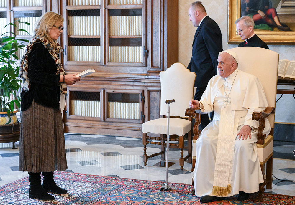 Pope Francis listens as Maeve Heaney, director of the Xavier Centre of Theology at the Australian Catholic University, speaks to him on behalf of the International Network of Societies for Catholic Theology in the library of the Apostolic Palace at the Vatican May 10, 2024. (CNS/Vatican Media)