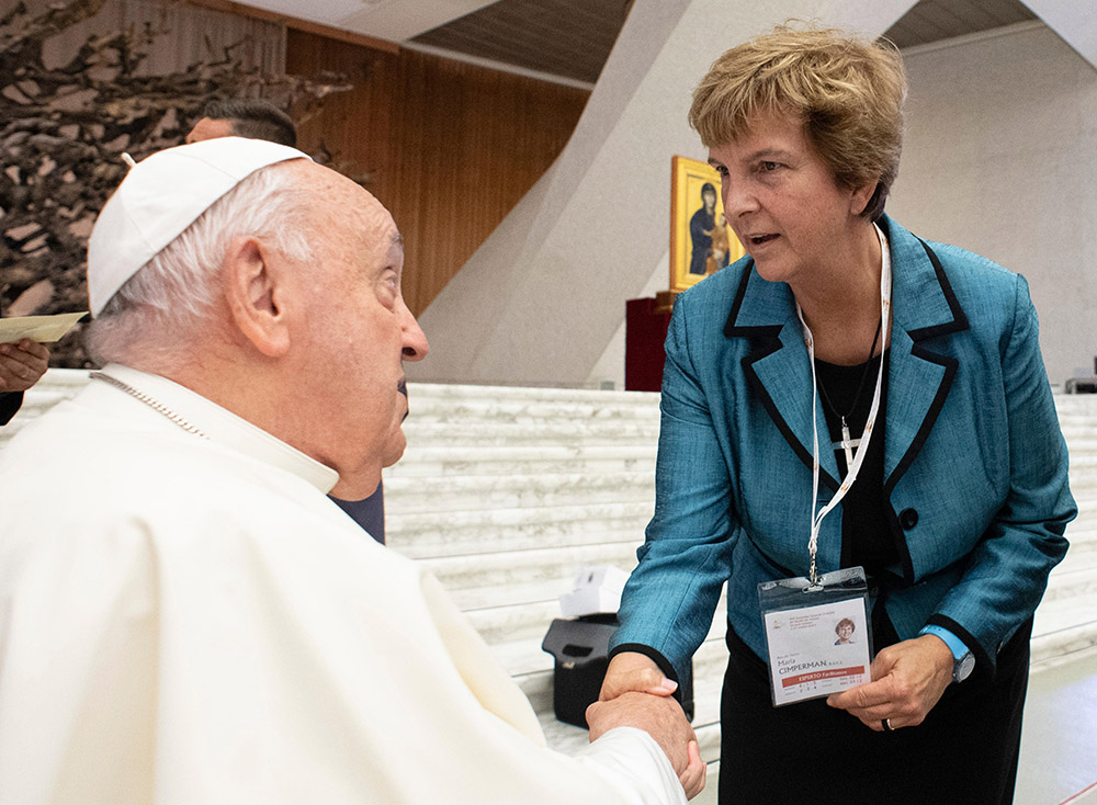 Pope Francis greets synod delegate Sr. Maria Cimperman, a Religious of the Sacred Heart of Jesus, before a working session of the Synod of Bishops on synodality at the Vatican Oct. 4, 2024. (CNS/Vatican Media)