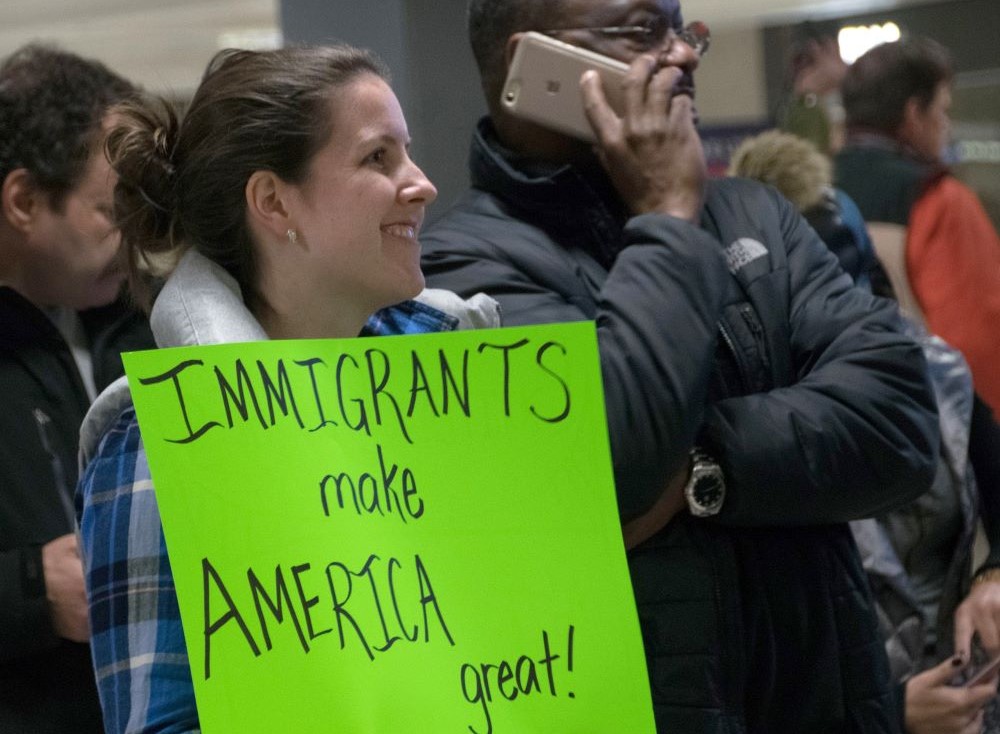 "Immigrants make America great" sign at protest