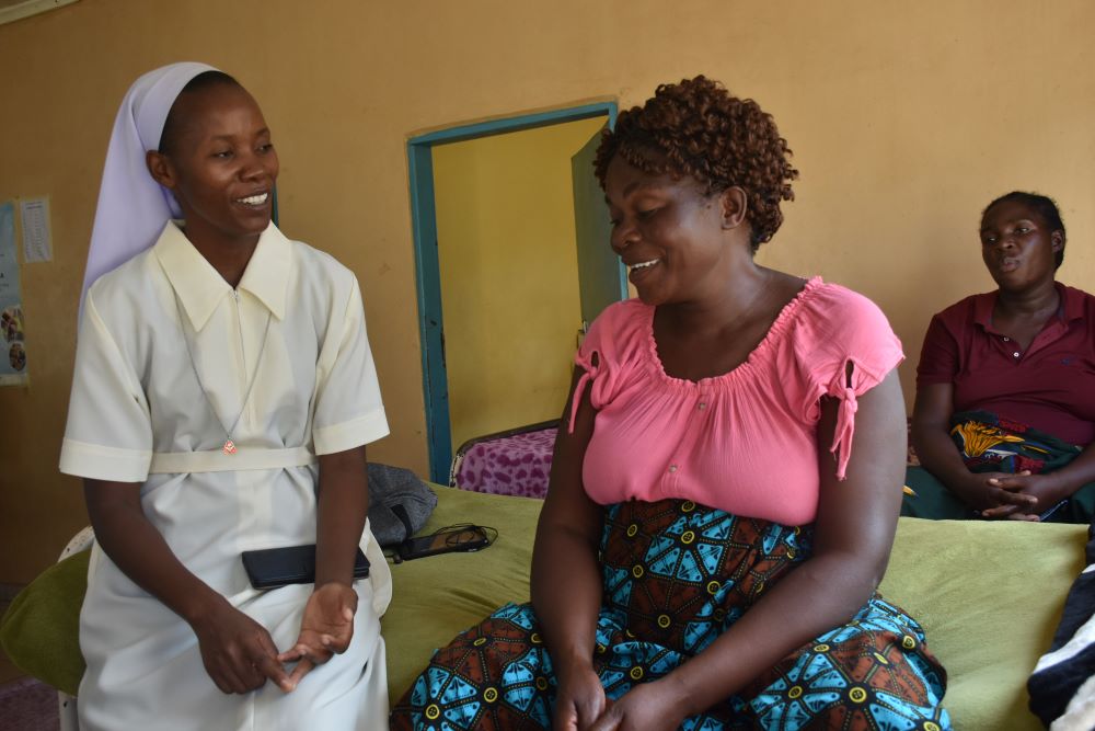 Holy Spirit Sr. Joyce Miyanda interacts with an expectant mother.