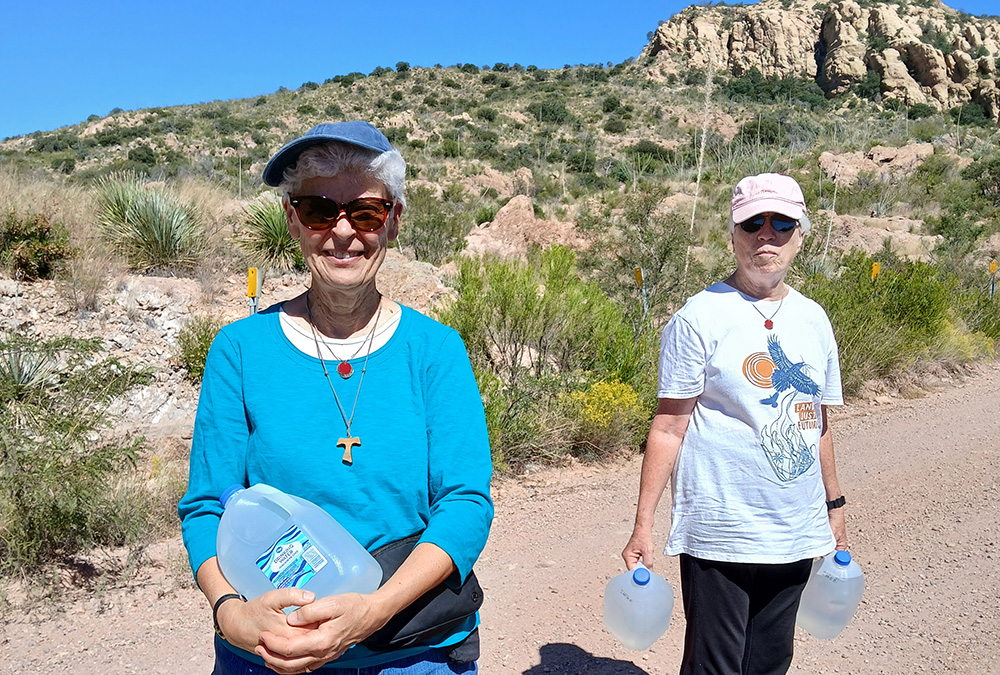 Sr. Diana De Bruin, a Sister of St. Francis of Assisi, Milwaukee, and Dominican Sr. Gemma Doll prepare to make a water drop in the Sonoran desert along a suspected migrant trail. (Courtesy of Kino Border Initiative)