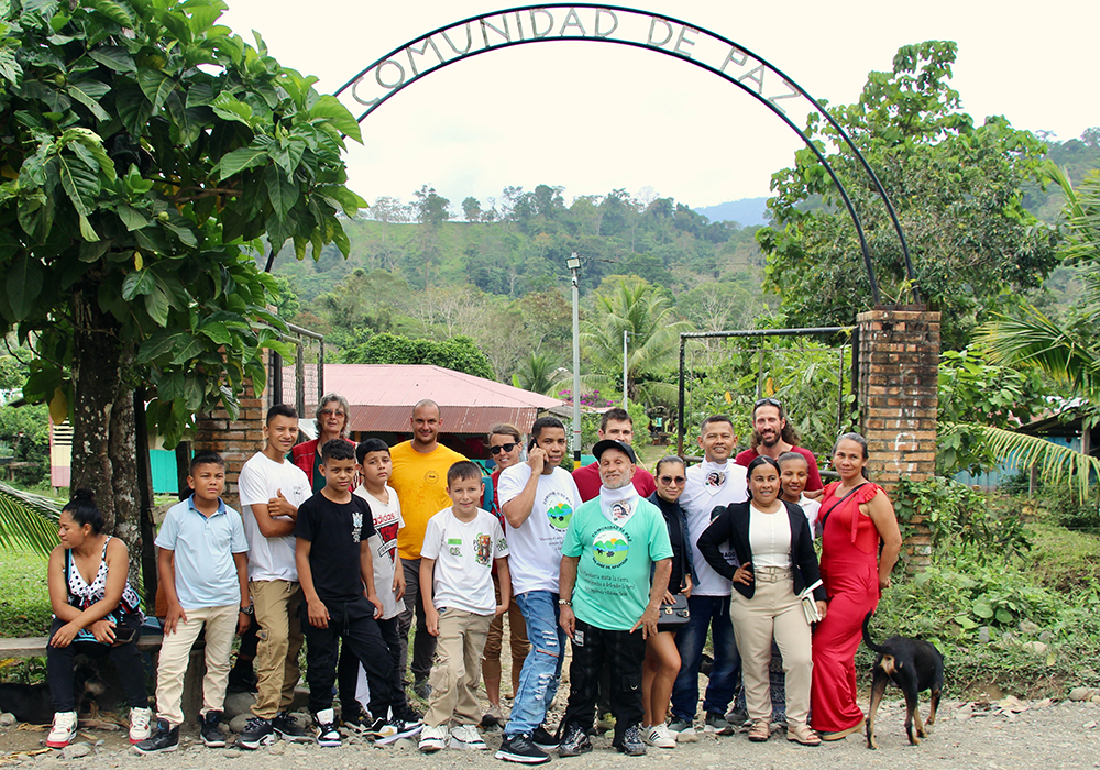 The entrance to the Peace Community is pictured, with a contingent waiting for a bus in San José de Apartadó, Colombia. (Tracy L. Barnett)