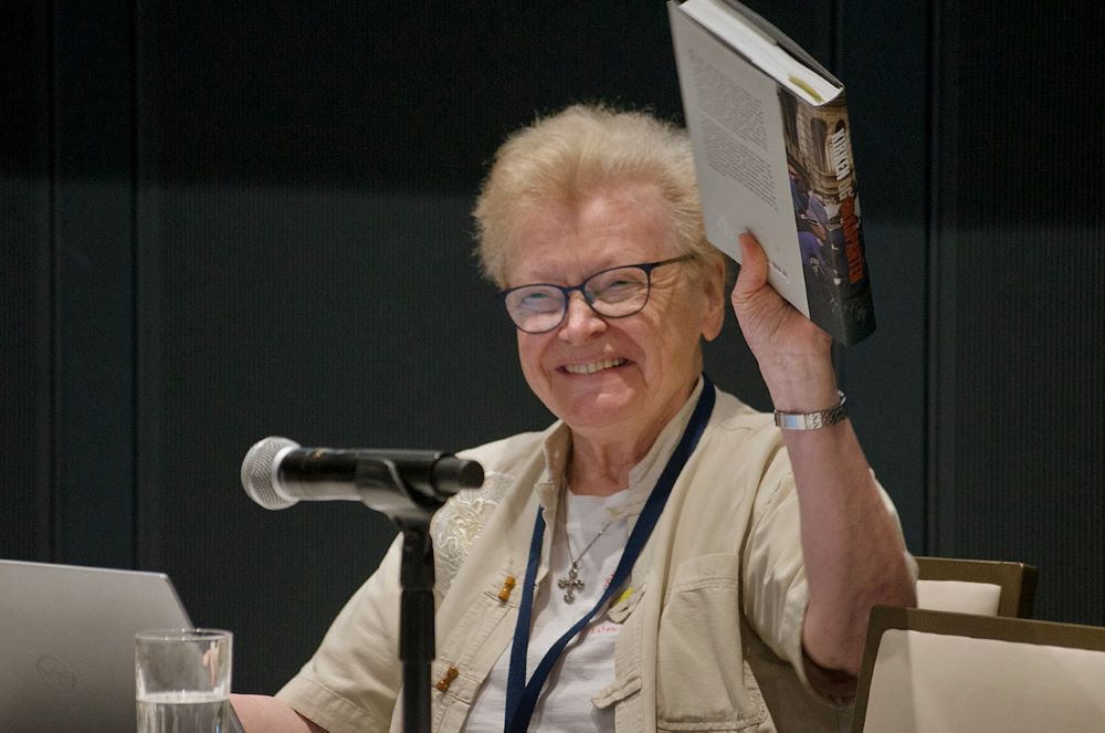 Sr. Else-Britt Nilsen holds a copy of her book.