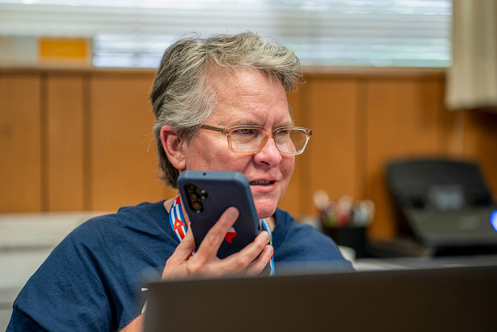 In Kerrville, Texas, the epicenter of the flash flooding and response effort, Daughter of Charity Sr. Denise LaRock processes aid requests received on the hotline phone of Catholic Charities of the San Antonio Archdiocese. (GSR photo/Gregg Brekke)
