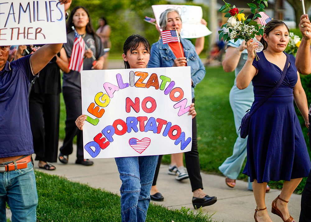 People attend a pro-immigrant march and rally following a Spanish-language Mass at St. John the Evangelist Church in Riverhead, N.Y., June 22, 2025, the feast of the Body and Blood of Christ. St. John's parish social ministry organized the event, which drew about 300 participants. The parish serves a large number of Latin American immigrants who live and work on the East End of Long Island. (OSV News/Gregory A. Shemitz)