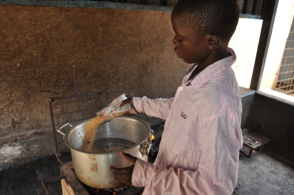 Boy with pot of rice