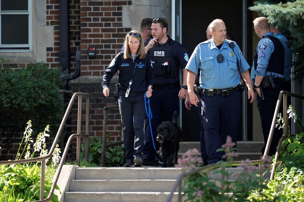 Law enforcement officers gather outside the Annunciation Catholic School as they respond to a mass shooting Aug. 27 in Minneapolis. Law enforcement officers gather outside the Annunciation Catholic School as they respond to a mass shooting Aug. 27 in Minneapolis.