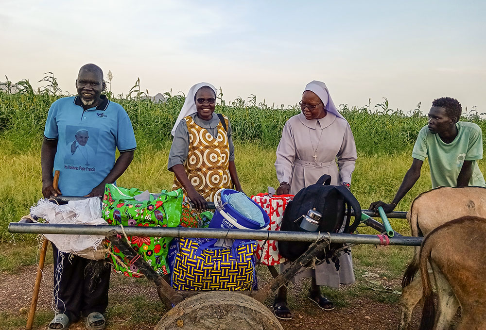 Catholic sisters and local residents load relief supplies onto a donkey cart in El Obeid, Sudan, preparing to deliver aid to displaced families in remote areas. (Courtesy of Sisters of the Sacred Heart of Jesus)