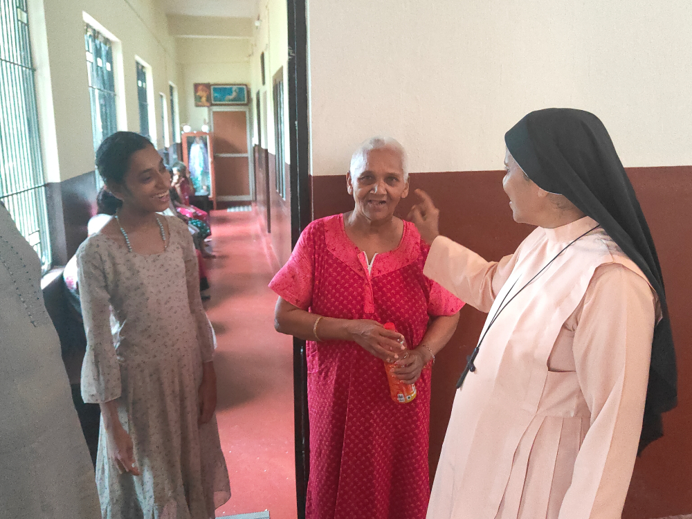 Bethany Sr. Bhagya Thalichirayil interacts with "Didi" (red), a senior resident, and Sujatha (left), the youngest resident of Asha Bhavan, a home for disabled and abandoned women at Ichilampady, a village in Karnataka state, southwestern India. (Thomas Scaria) Bethany Sr. Bhagya Thalichirayil interacts with "Didi" (red), a senior resident, and Sujatha (left), the youngest resident of Asha Bhavan, a home for disabled and abandoned women at Ichilampady, a village in Karnataka state, southwestern India. (Thomas Scaria)
