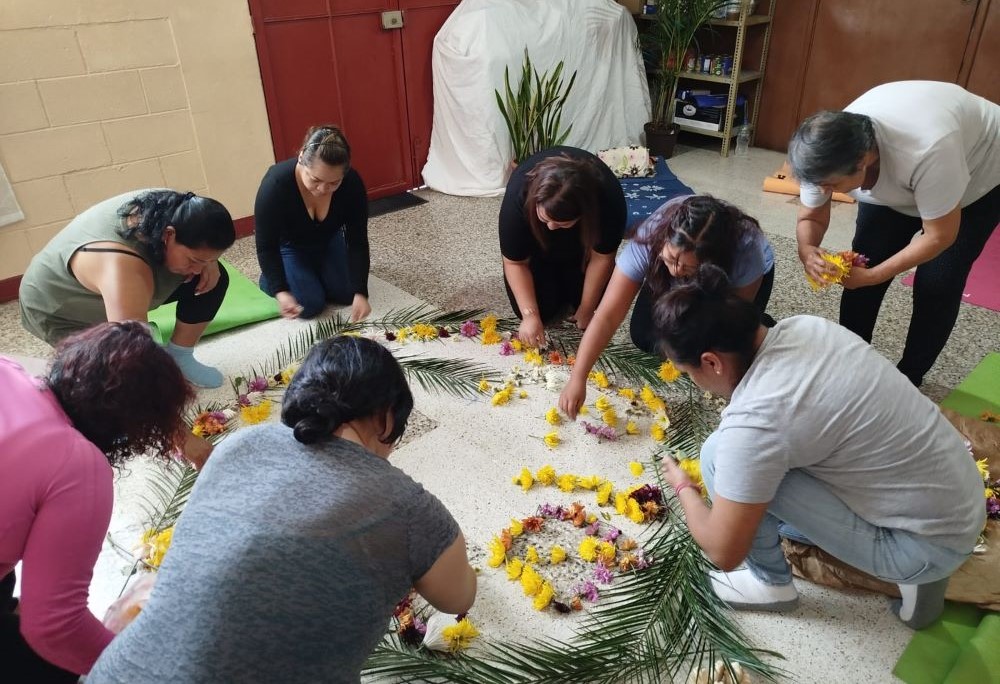 Women create a flower mandala as a symbol of gratitude. Women create a flower mandala as a symbol of gratitude.