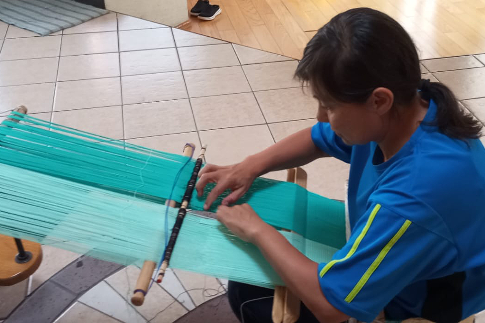 Lourdes Munguia works at a backstrap loom. (Courtesy of Lourdes Munguia) Lourdes Munguia works at a backstrap loom. (Courtesy of Lourdes Munguia)
