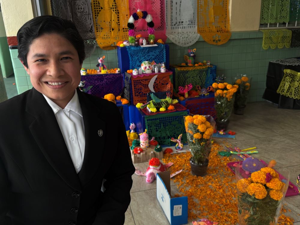Sr. Brenda Hernández poses in front of a Day of the Dead altar. 