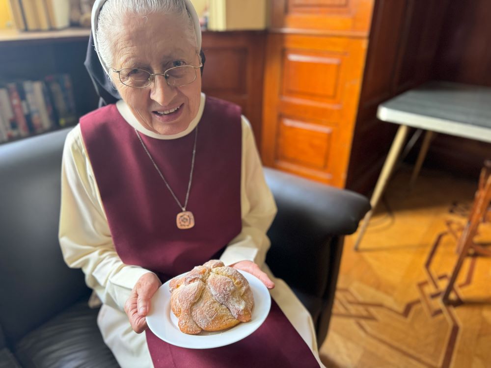 Sr. María Celina Mota Campos, of the Order of the Incarnate Word and Blessed Sacrament, explains the significance of bread of the dead Oct. 27 in Mexico City, where Day of the Dead celebrations focus on remembering those who have died. 
