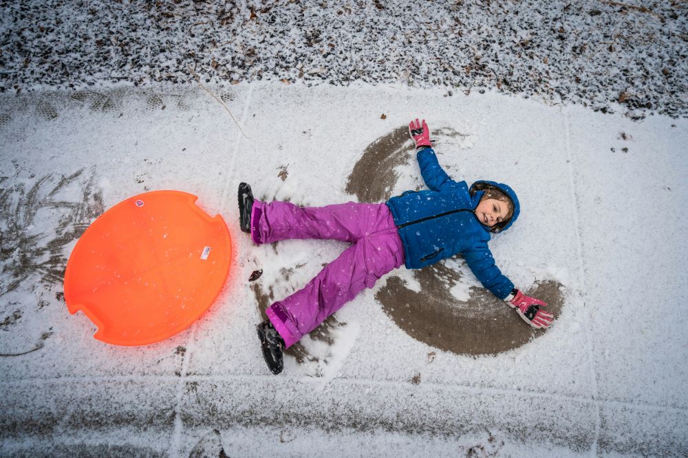 Child makes snow angel