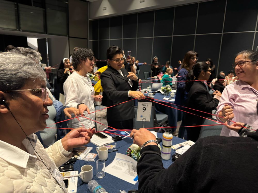 Sisters pull on a string to illustrate networking during the Conrad N. Hilton Foundation's Catholic Sisters Initiative Convening Oct. 29, 2025 in Mexico City.