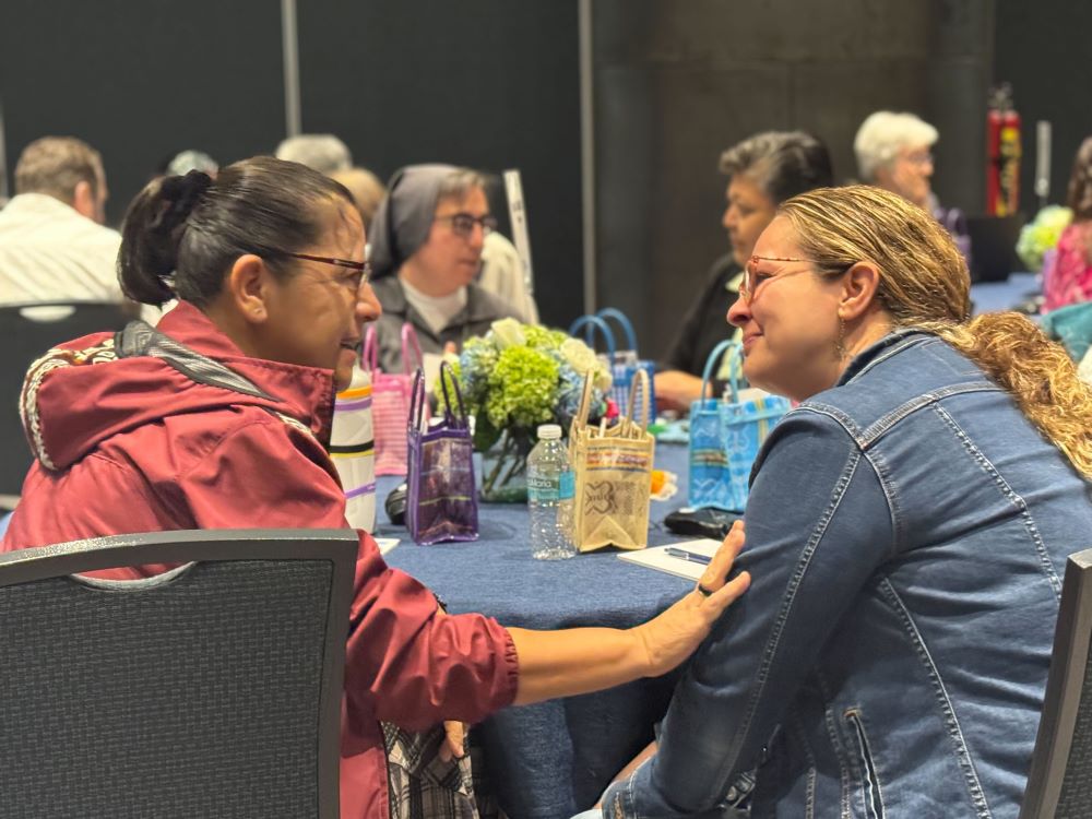 Comboni Sr. Clara Torres and Karina Frias talk during the Conrad N. Hilton Foundation's Catholic Sisters Initiative Convening Oct. 30,.